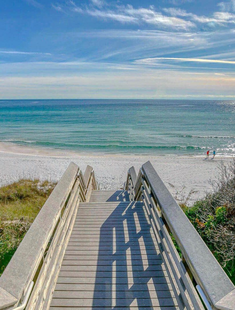 Wooden beach boardwalk leading to a white-sand beach on Florida's 30A