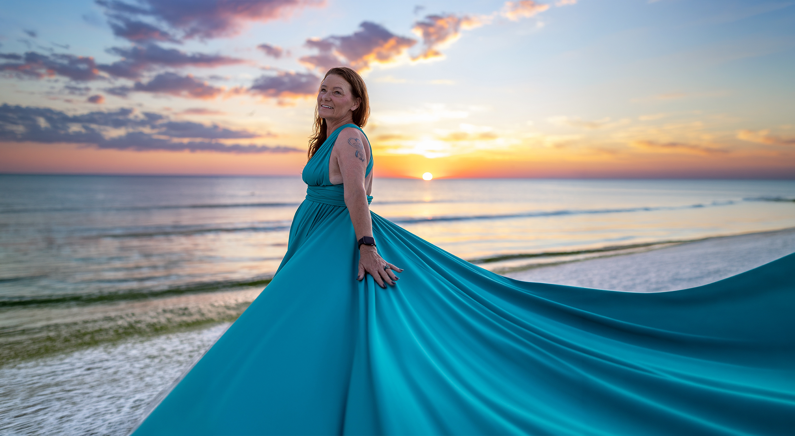 SUNSET~4 Woman in a teal flying dress on the beach at sunset